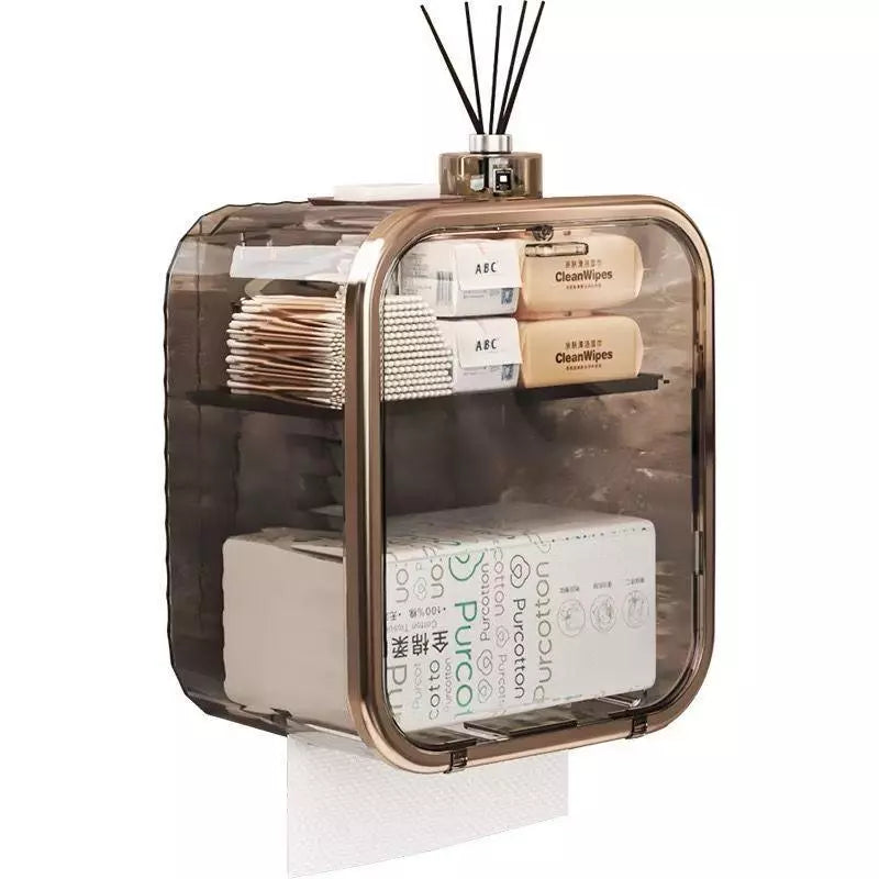Organizador de banheiro com tampa fumê, espaço para lenços e caixa de papel; difusor aromático apoiado no topo.